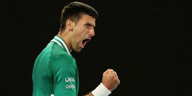 Serbia's Novak Djokovic celebrates winning the third set during his quarterfinal match against Germany's Alexander Zverev.