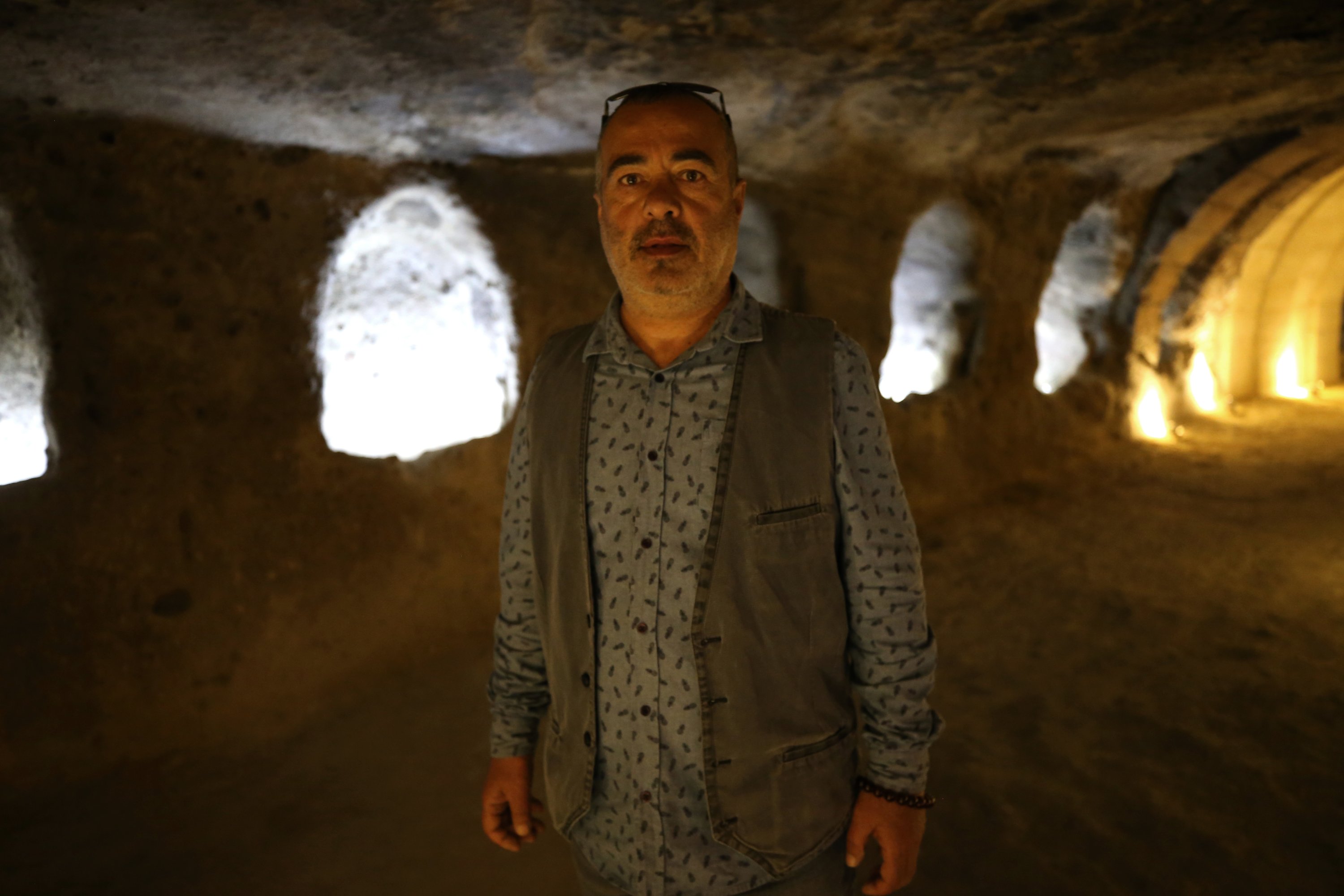 Archaeologist Semih Istanbulluoğlu in Kayaşehir, a historical rock-carved hillside settlement in Nevşehir that will welcome tourists from the first week of May, Cappadocia, Turkey, April 25, 2022. (AA Photo)