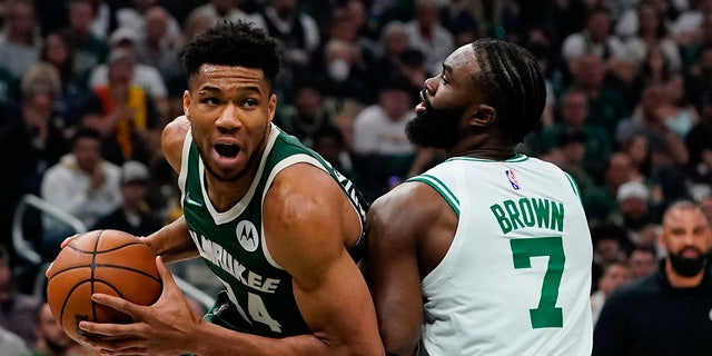 Milwaukee Bucks' Giannis Antetokounmpo is fouled by Boston Celtics' Jaylen Brown during the first half of Game 6 of an NBA basketball Eastern Conference semifinals playoff series Friday, May 13, 2022, in Milwaukee . (AP Photo/Morry Gash)