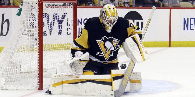 May 13, 2022; Pittsburgh, Pennsylvania, USA;  Pittsburgh Penguins goaltender Louis Domingue (70) makes a save against the New York Rangers during the third period in game six of the first round of the 2022 Stanley Cup Playoffs at PPG Paints Arena. The Rangers won 5-3.  Mandatory Credit: Charles LeClaire-USA TODAY Sports