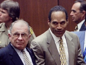OJ Simpson reacts next to F. Lee Bailey after the court clerk announces that Simpson was found not guilty of the murders of Nicole Simpson and Ronald Goldman, October 3, 1995.