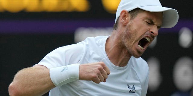Britain's Andy Murray celebrates winning the third set during the singles tennis match against John Isner of the US on day three of the Wimbledon tennis championships in London, Wednesday, June 29, 2022. 