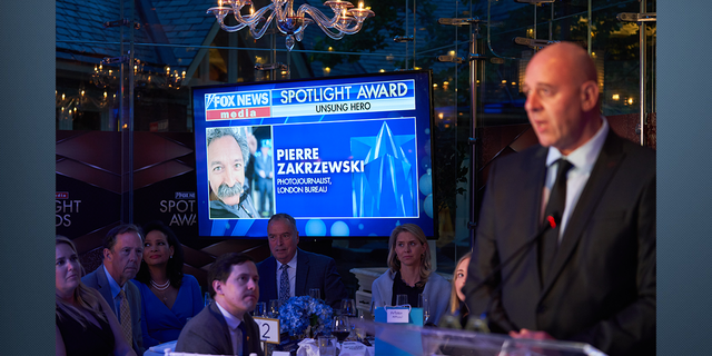 FOX News London Bureau Chief Dragan Petrovic accepting the Unsung Hero award on behalf of Pierre Zakrzeswki