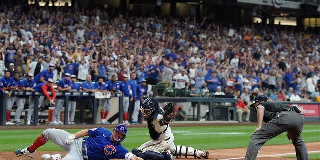 Chicago Cubs' Seiya Suzuki slides safely home after hitting an inside-the-park home run during the ninth inning of a baseball game against the Milwaukee Brewers Monday, July 4, 2022, in Milwaukee. 