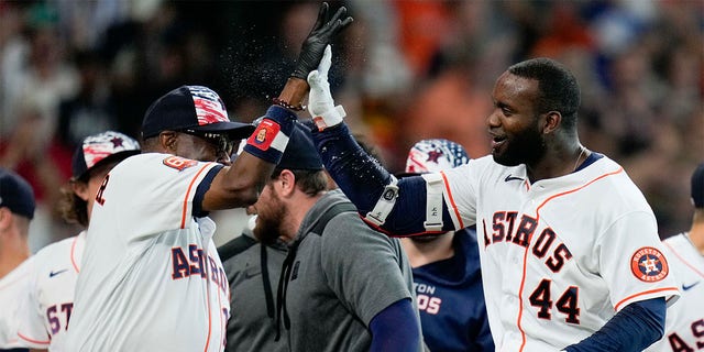 Houston Astros designated hitter Yordan Alvarez (44) celebrates his walkoff home run with manager Dusty Baker during the ninth inning of a baseball game against the Kansas City Royals, Monday, July 4, 2022, in Houston. 