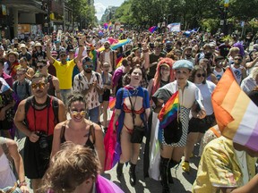 People march on Ste-Catherine St. in the Gay Village area of Montreal Sunday, August 7, 2022. This was during a protest march that was made after the Pride Parade was cancelled.