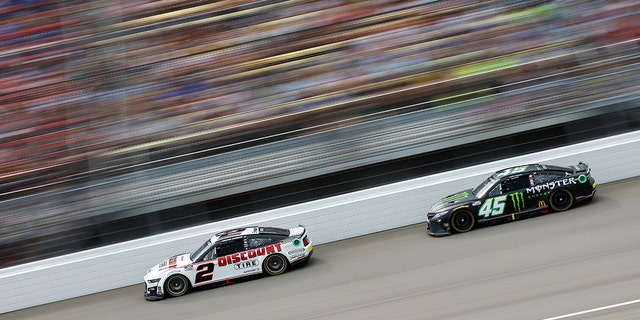 Austin Cindric, driver of the #2 Discount Tire Ford, and Ty Gibbs, driver of the #45 Monster Energy Toyota, race during the FireKeepers Casino 400 at Michigan International Speedway, Aug. 7, 2022, in Brooklyn, Michigan.