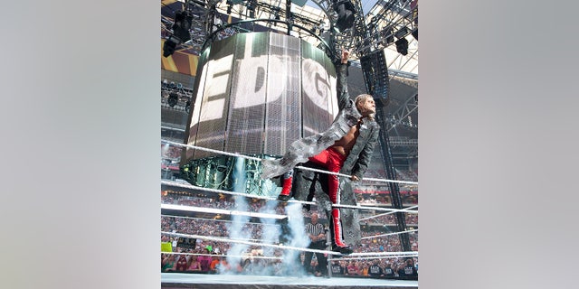 Edge embraces the crowd in the ring.