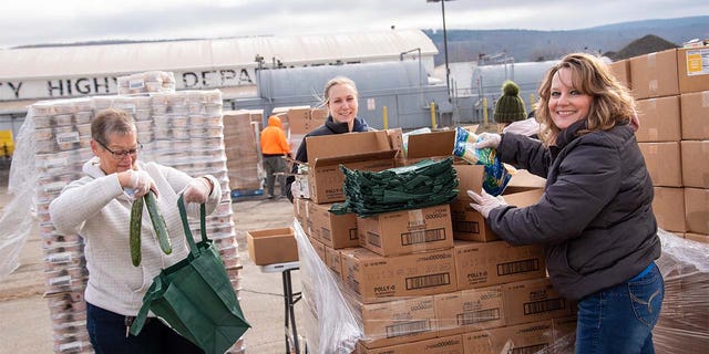 Food Bank of the Southern Tier volunteers load up cars at a "no-contact" food distribution event during the COVID-19 pandemic. 