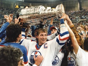 Edmonton Oilers team captain Wayne Gretzky holds up the Stanley Cup trophy after winning the Stanley Cup finals in Edmonton on June 1, 1987.