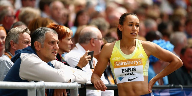 Jessica Ennis-Hill of Great Britain talks with coach Tony Minichiello while competing in the women's long jump at the Sainsbury's Anniversary Games at The Stadium — Queen Elizabeth Olympic Park July 25, 2015, in London.  