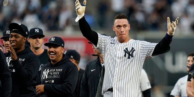 The New York Yankees' Aaron Judge, right, gestures to fans after a game against the Tampa Bay Rays Oct. 3, 2021, in New York. 