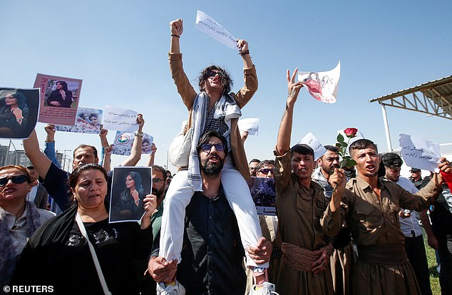 People take part in a protest following the death of Mahsa Amini in front of the United Nations headquarters in Erbil, Iraq