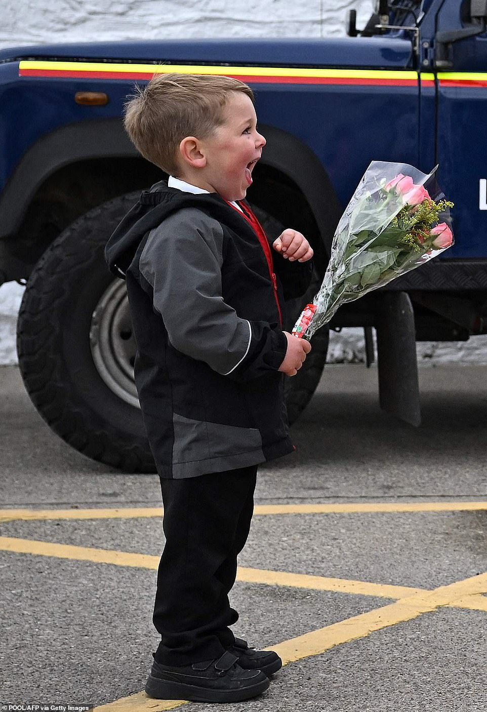Four-year-old schoolboy Theo Crompton prepares to hand a bouquet of flowers to the Princess of Wales this afternoon