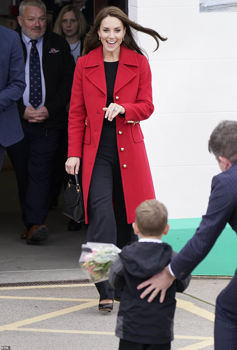 The Princess of Wales receives a posy of flowers during a visit to the RNLI Holyhead Lifeboat Station, in Holyhead, Wales