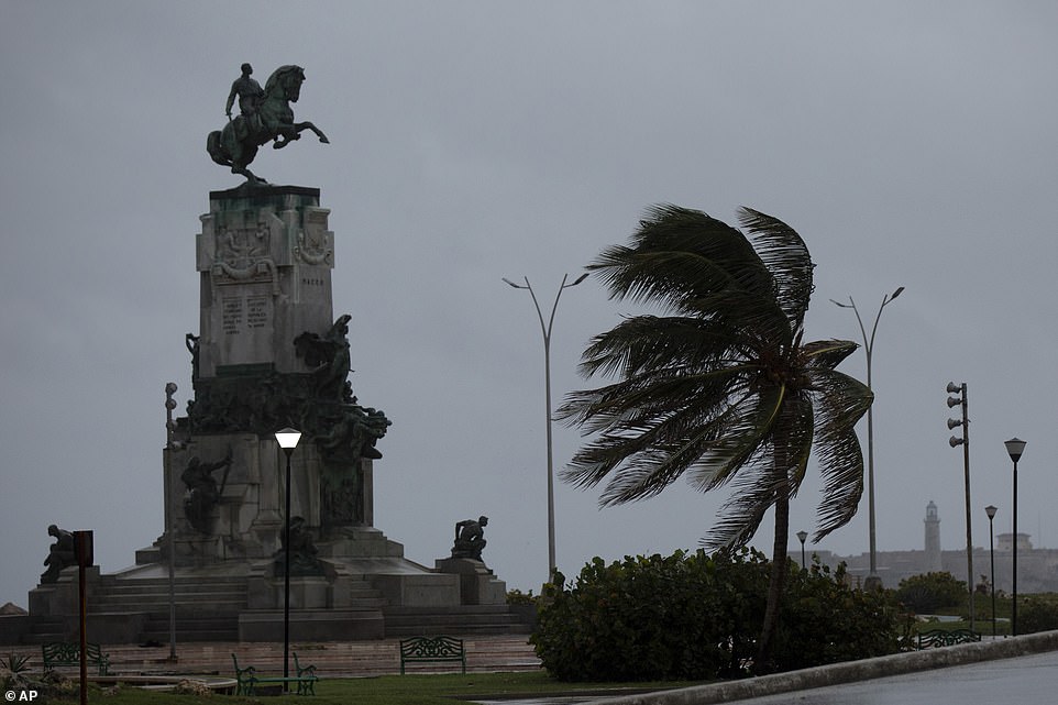 Strong winds are already battering palm tree's at the Antonio Maceo Monument in Havana, Cuba, early on  Tuesday morning