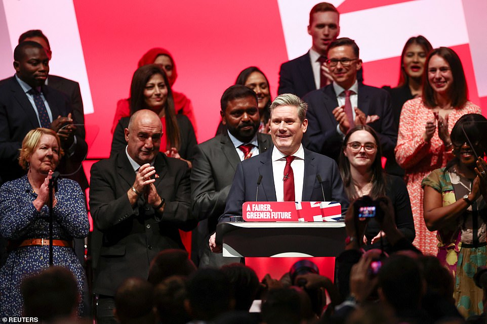 Sir Keir was flanked by party activists on the stage as he gave his speech today