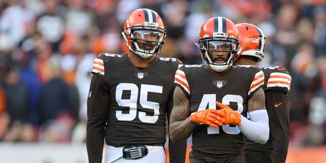 Cleveland Browns defensive end Myles Garrett (95) and safety John Johnson are shown during the fourth quarter against the Baltimore Ravens at FirstEnergy Stadium in Cleveland on Dec. 12, 2021.
