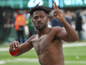 Then Tampa Bay Buccaneers wide receiver Antonio Brown gestures to the crowd as he leaves the field.