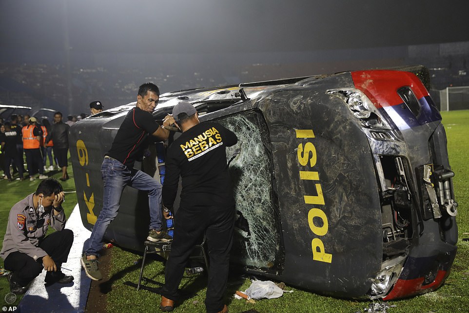 The rioting spread outside the stadium where at least five police vehicles were overturned and set on fire amid the chaos