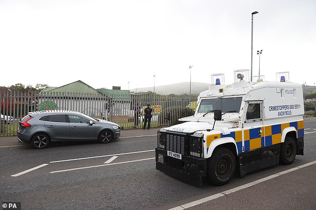 Officers from the PSNI and an armoured vehicle at the scene of a shooting at the clubhouse of Donegal Celtic Football Club, in west Belfast on Sunday