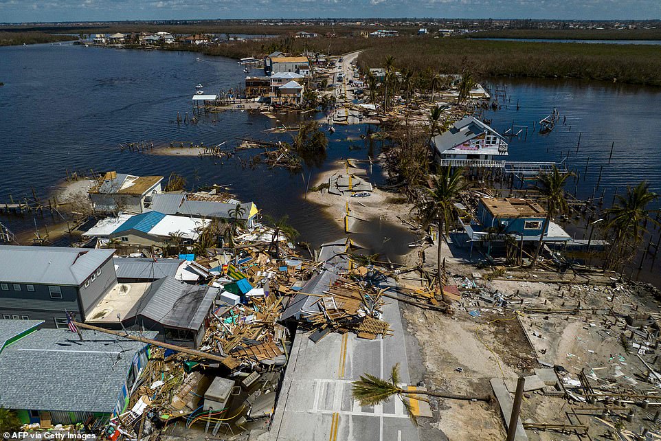 A broken section of the Pine Island Road and destroyed houses in the aftermath of Hurricane Ian in Matlacha, Florida. The death toll has reached 100 in Florida, according to officials