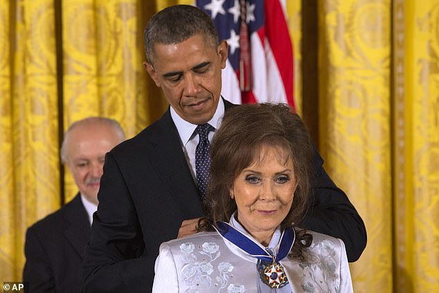 An honor: As a songwriter, she crafted a persona of a defiantly tough woman, a contrast to the stereotypical image of most female country singers. The Country Music Hall of Famer wrote fearlessly about sex and love, cheating husbands, divorce. Seen getting the Presidential Medal of Freedom from President Barack Obama in 2013 (pictured)