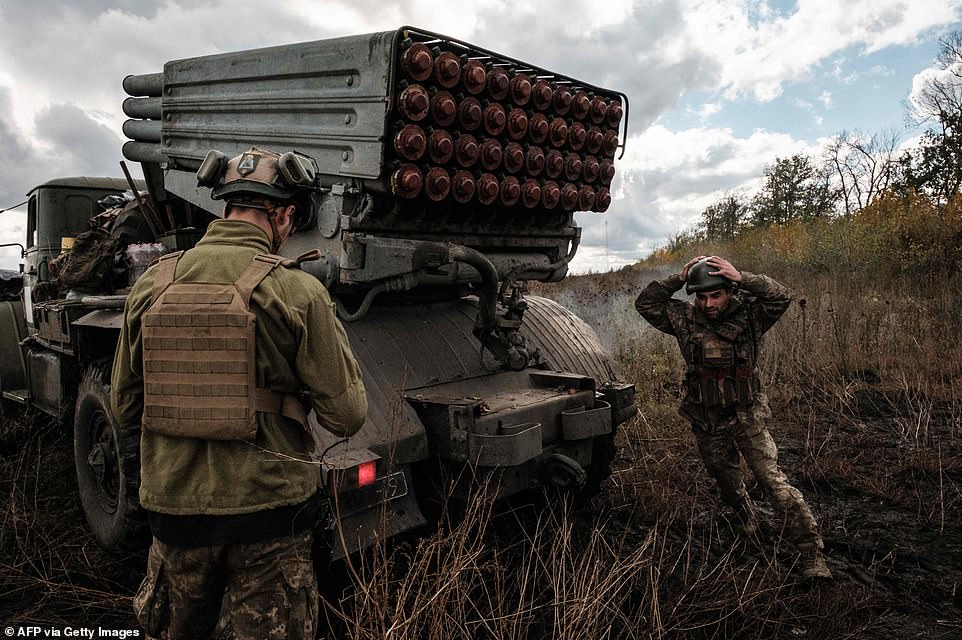 Ukrainian soldiers prepare to fire a BM-21 'Grad' multiple rocket launcher towards Russian positions in Kharkiv region