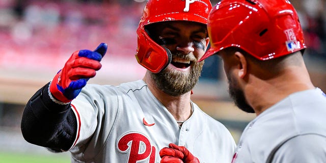 Bryce Harper #3 of the Philadelphia Phillies congratulates Kyle Schwarber, #12, after Schwarber hit a homerun in the first inning against the Houston Astros at Minute Maid Park on Oct. 3, 2022 in Houston. 