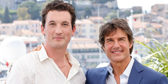 Miles Teller and Tom Cruise attend the photocall of "Top Gun: Maverick" during the 75th annual Cannes film festival at Palais des Festivals on May 18, 2022 in Cannes, France. 