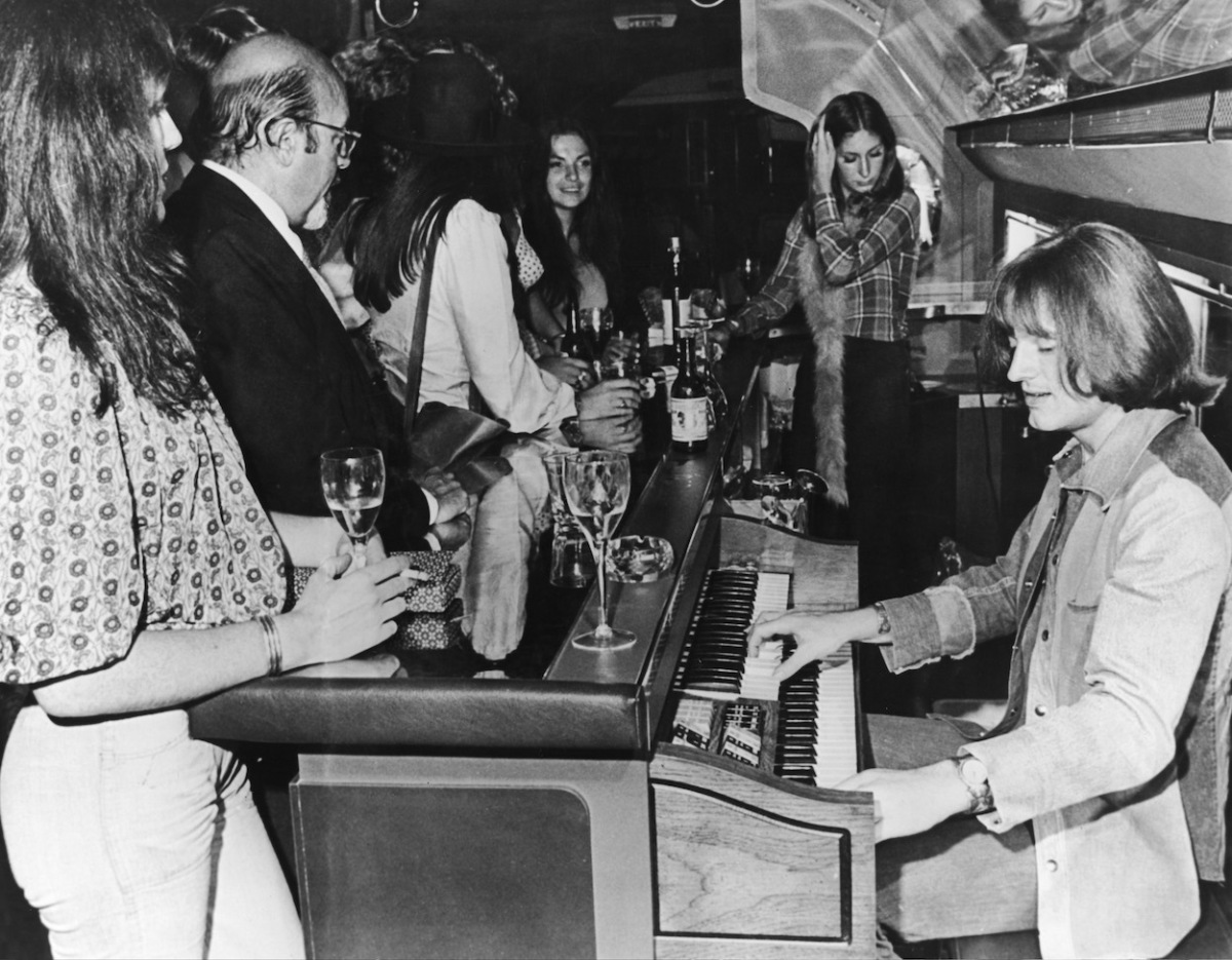 John Paul Jones plays the organ aboard Led Zeppelin's airplane in 1973.