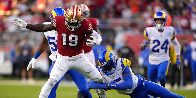 Wide receiver Deebo Samuel #19 of the San Francisco 49ers rushes for a touchdown as he breaks a tackle by cornerback Jalen Ramsey #5 of the Los Angeles Rams during the second quarter at Levi's Stadium on Oct. 3, 2022 in Santa Clara, California. 