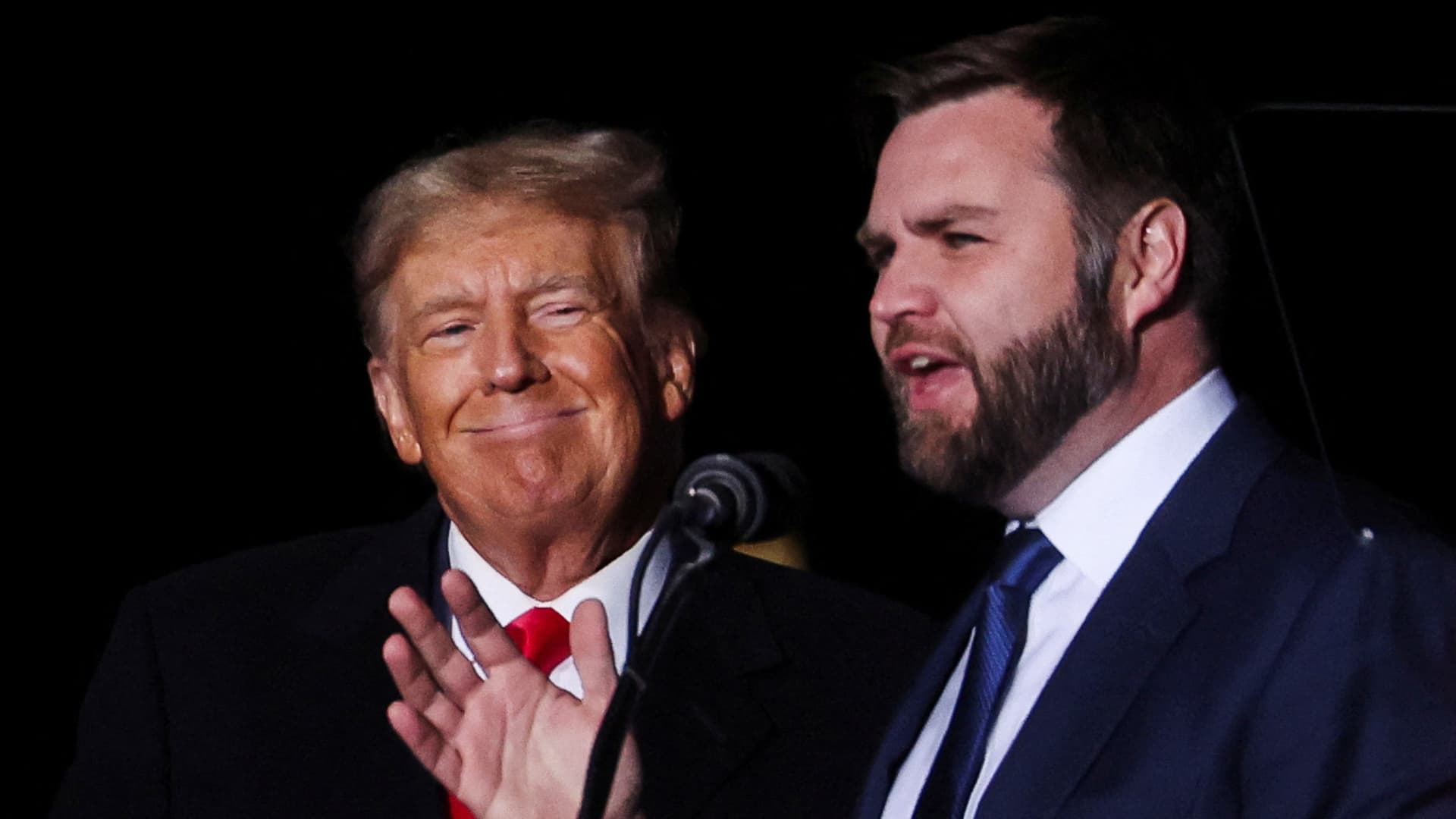 U.S. Senate Republican candidate J.D. Vance speaks as former U.S. President Donald Trump smiles at a rally to support Republican candidates ahead of midterm elections, in Dayton, Ohio, U.S. November 7, 2022. 