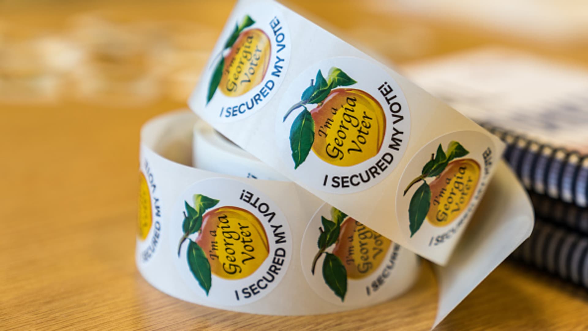 Stickers sit on a table at a polling location on November 8, 2022 in Atlanta, Georgia.