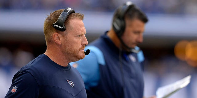 Tennessee Titans offensive coordinator Todd Downing looks on as Tennessee Titans Head Coach Mike Vrabel checks his play card during the NFL football game between the Tennessee Titans and the Indianapolis Colts on Oct. 31, 2021, at Lucas Oil Stadium in Indianapolis.