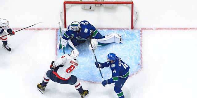 Washington Capitals' Alex Ovechkin scores a goal on Canucks goaltender Spencer Martin on Nov. 29, 2022, in Vancouver.