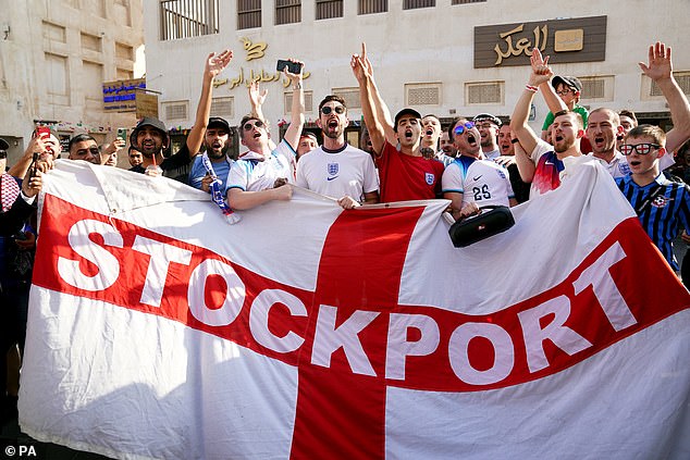 England fans with a Stockport County flag, in the Souq area of Doha,
