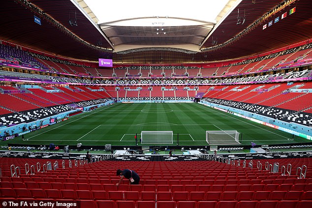 Workers prepare the Al Bayt stadium hours before fans being flocking in to witness the round of 16 clash between England and Senegal