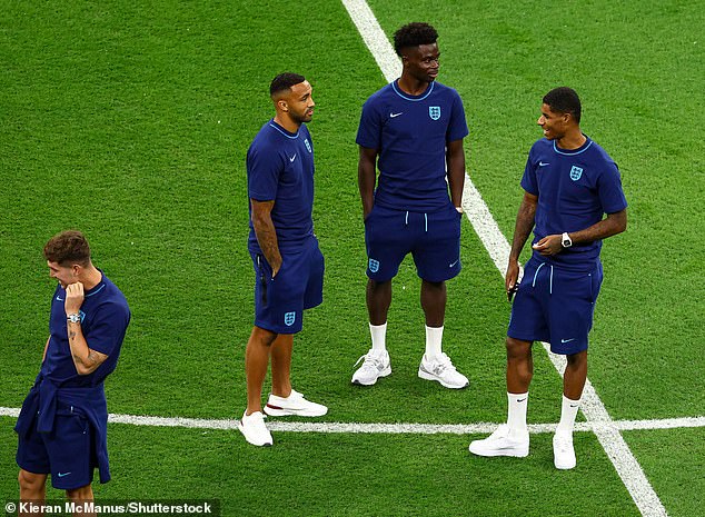 Marcus Rashford of England talks to Bukayo Saka of England and Callum Wilson of England as they inspect the pitch before the match