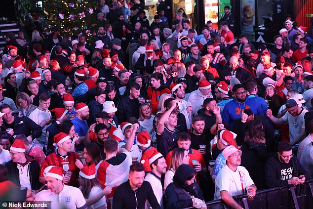 England supporters wear Christmas hats as they watch the Three Lions' clash with Senegal