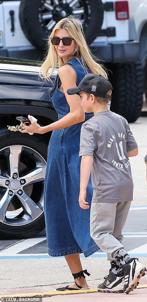 The former first daughter carried her son's tee-ball trophy in her hand as they made their way to their car