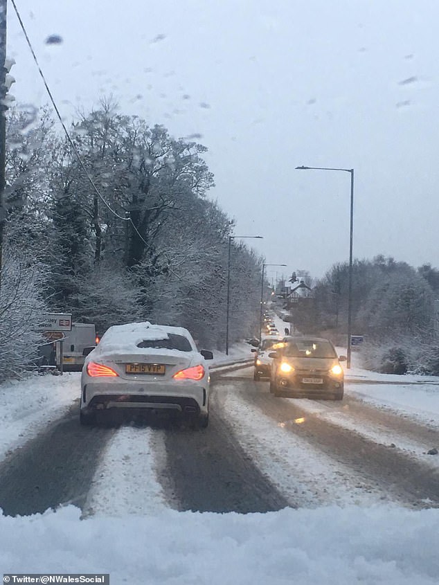 Drivers are seen battling wintry conditions on the roads in North Wales this morning after snow fall over night