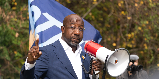 Sen. Raphael Warnock meets with community members on the first day of early voting on Oct. 17, 2022, in Duluth, Georgia.