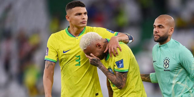 Neymar, of Brazil, reacts with Thiago Silva, left, and Dani Alves after the loss via a penalty shootout during the FIFA World Cup Qatar 2022 quarterfinal match between Croatia and Brazil at Education City Stadium on Dec. 9, 2022 in Al Rayyan, Qatar. 