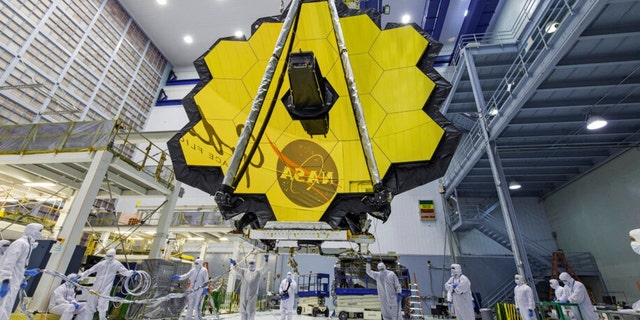 In this April 13, 2017, photo provided by NASA, technicians lift the mirror of the James Webb Space Telescope using a crane at the Goddard Space Flight Center in Greenbelt, Md.