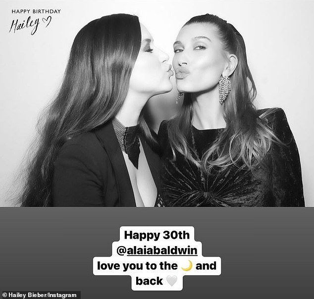 Sisters: To celebrate her sibling's birthday, Hailey shared a sweet throwback of herself as a baby as Alaia planted a sweet kiss on her cheek