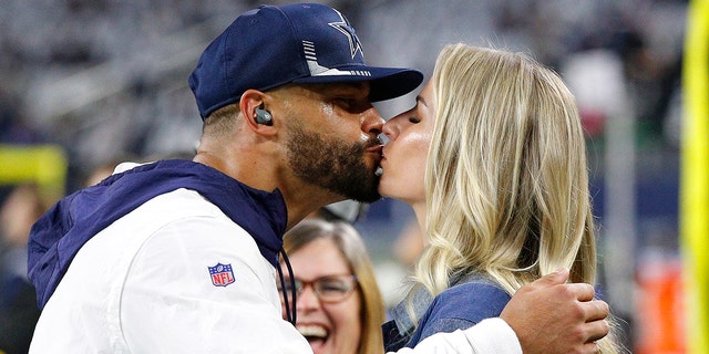 Dak Prescott #4 of the Dallas Cowboys kisses his girlfriend Natalie Buffett before the game against the Washington Football Team at AT&amp;T Stadium on December 26, 2021 in Arlington, Texas. 