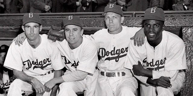 From left, Brooklyn Dodgers third baseman John Jorgensen, shortstop Pee Wee Reese, second baseman Ed Stanky and first baseman Jackie Robinson before a baseball game against the Boston Braves at Ebbets Field in Brooklyn, New York, on April 15, 1947. 
