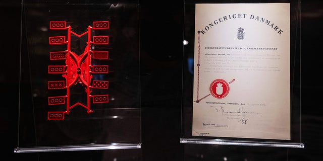 Early LEGO bricks are displayed next to a patent certificate at the LEGO Museum in Billund, Denmark.