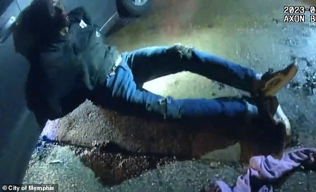 Nichols is seen sitting propped against a car following the beating on January 7